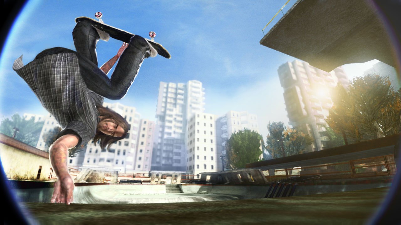 Skate. A skater mid-trick over a drained pool with a city skyline behind.